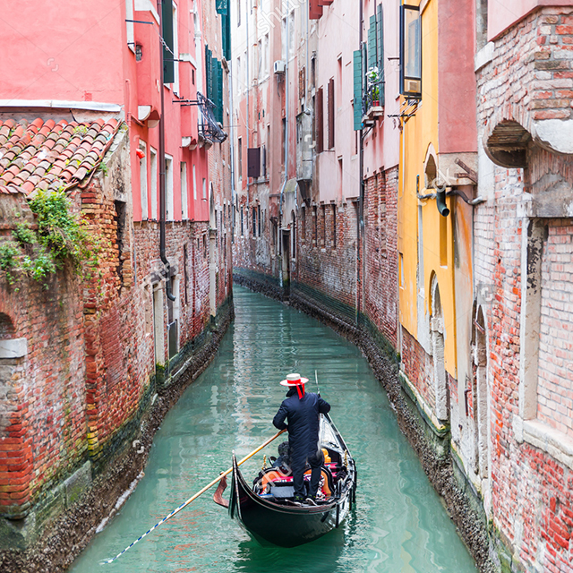 stock-photo-venetian-gondolier-punting-gondola-through-green-canal-waters-of-venice-italy-267588308